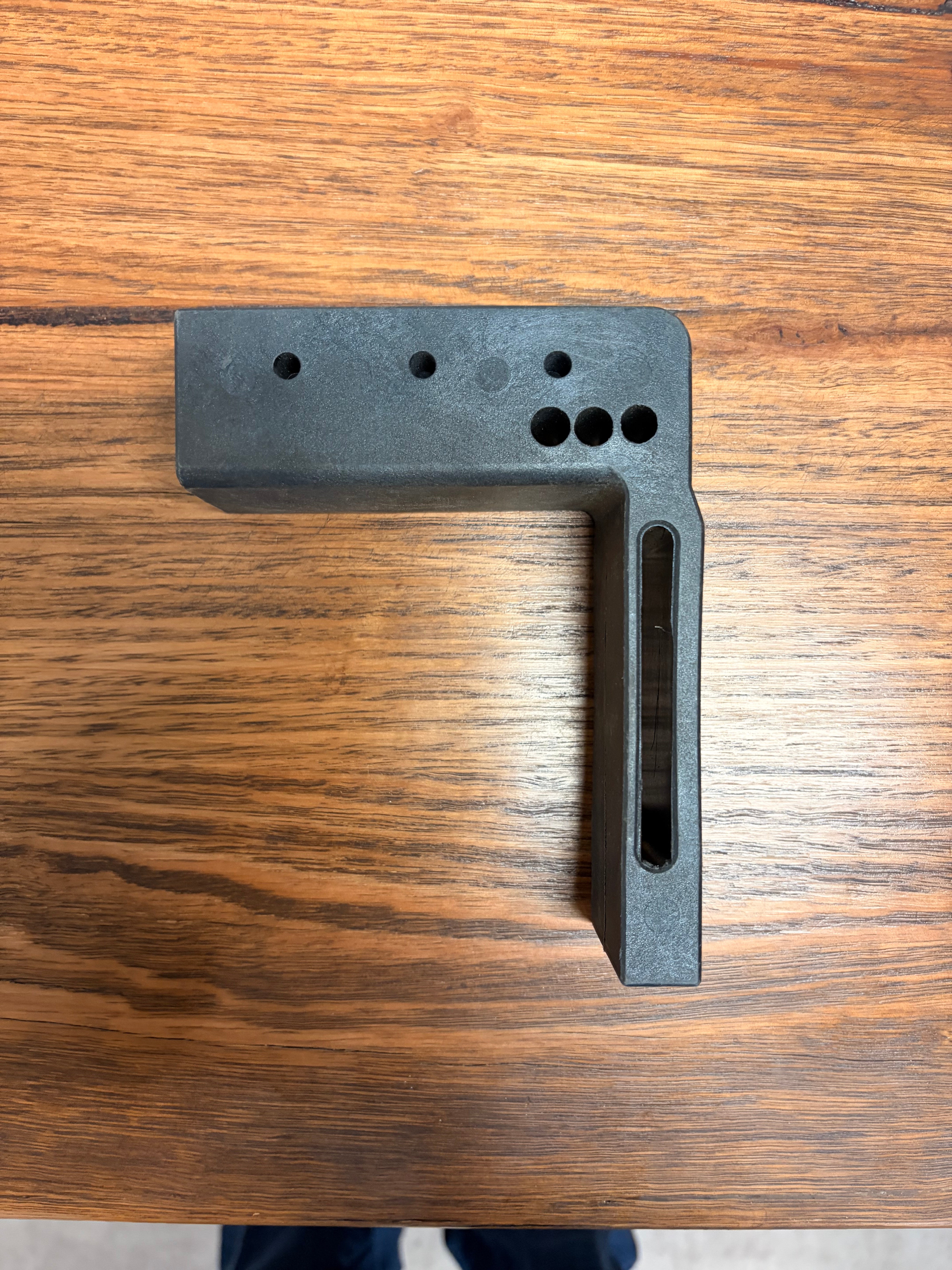 Bow end slotted leg — top view showing flat bow slot and cable holes