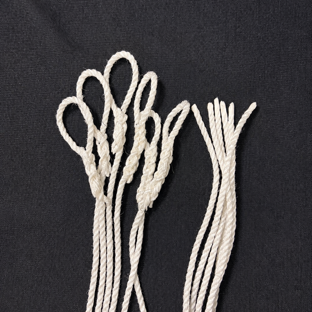 10mm silver pre-spliced truck tarp ropes showing spliced eyes and melted ends on a black background