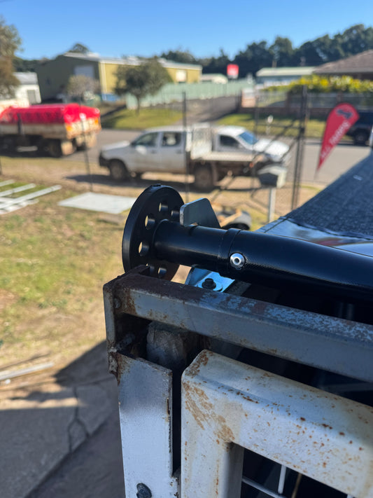 Bolt-on shark fin brackets for pull-out tarp system
