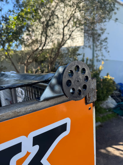 Bolt-on shark fin brackets for pull-out tarp system